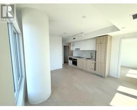 A spacious kitchen with white cabinets and a marble backsplash is seen in the image.