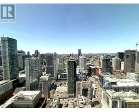 A cityscape with tall buildings and a clear sky.
