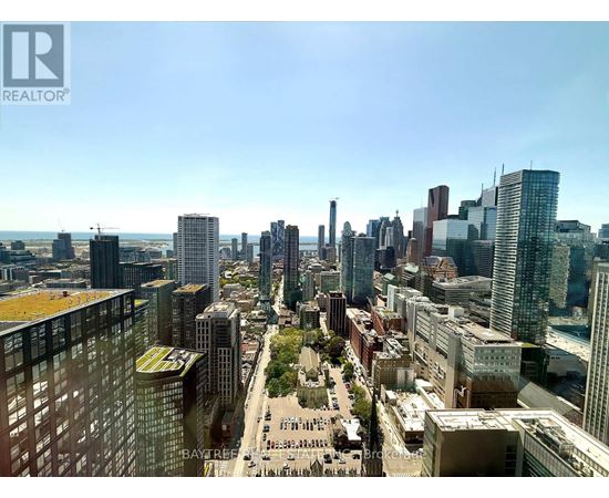 A cityscape with tall buildings and a clear sky.