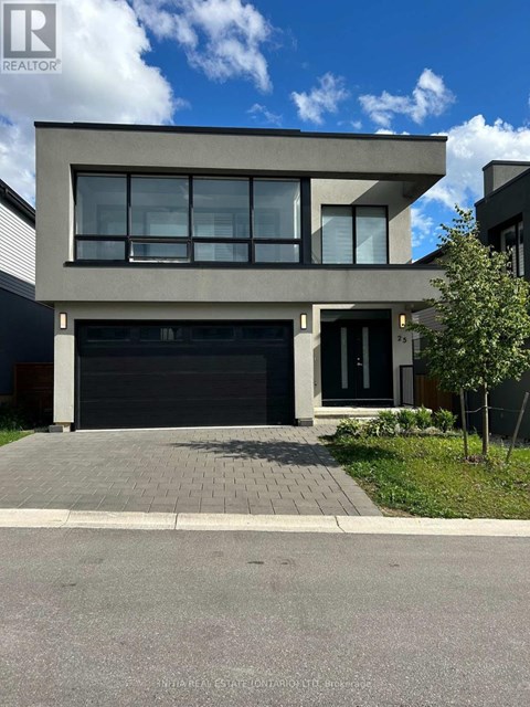 A modern house with a grey facade and a black garage door.