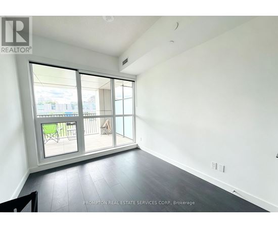 A room with a sliding glass door leading to a balcony.