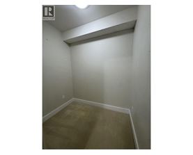 A small, empty room with a light on the ceiling.