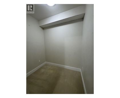 A small, empty room with a light on the ceiling.