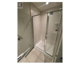 A glass shower stall in a bathroom.