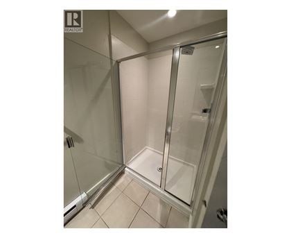A glass shower stall in a bathroom.