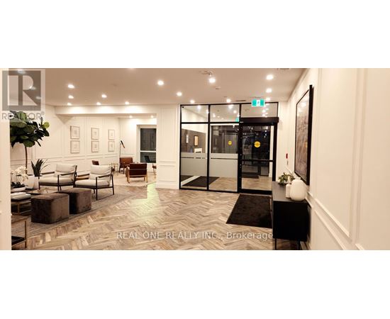 A spacious lobby with a marble floor and a reception desk.