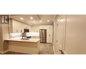 A kitchen with white cabinets and a countertop.