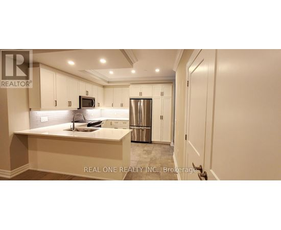 A kitchen with white cabinets and a countertop.