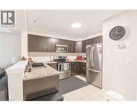 A kitchen with a granite countertop and stainless steel appliances.