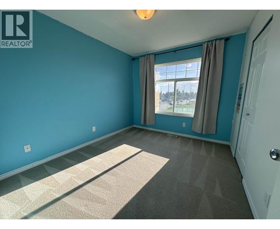 A room with blue walls and a carpeted floor.