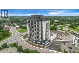A tall building with a parking lot in front of it.
