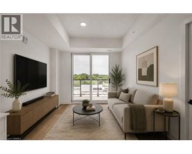 A living room with a flat screen TV, a sofa, a coffee table, and a potted plant.