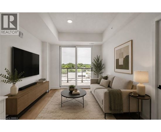 A living room with a flat screen TV, a sofa, a coffee table, and a potted plant.