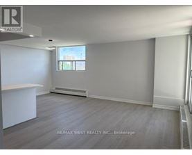 A spacious room with a window and a radiator is on the market through RE/MAX West Realty Inc.