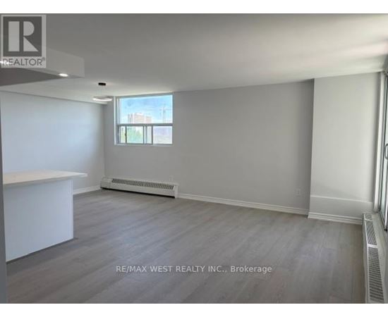 A spacious room with a window and a radiator is on the market through RE/MAX West Realty Inc.