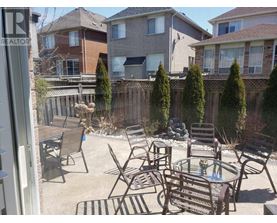 A patio with a table and chairs surrounded by a fence.