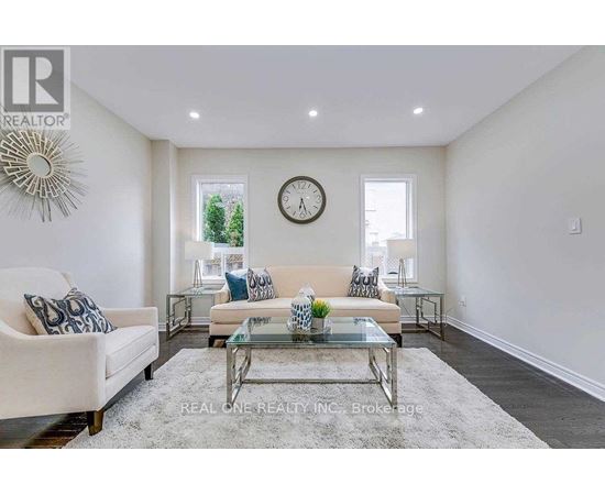 A living room with a glass coffee table and a white sofa.