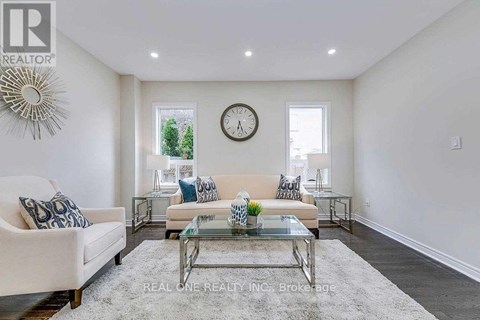 A living room with a glass coffee table and a white sofa.