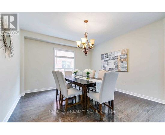A dining room with a wooden table and chairs.