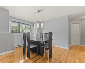 A dining room with a table and chairs.