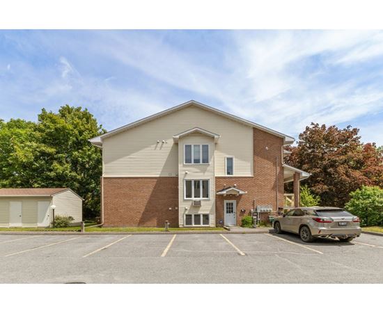 A building with a parking lot in front of it.