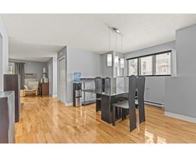 A kitchen with a dining table and chairs.