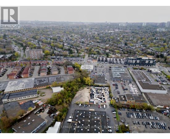 An aerial view of a city with a large parking lot in the foreground.
