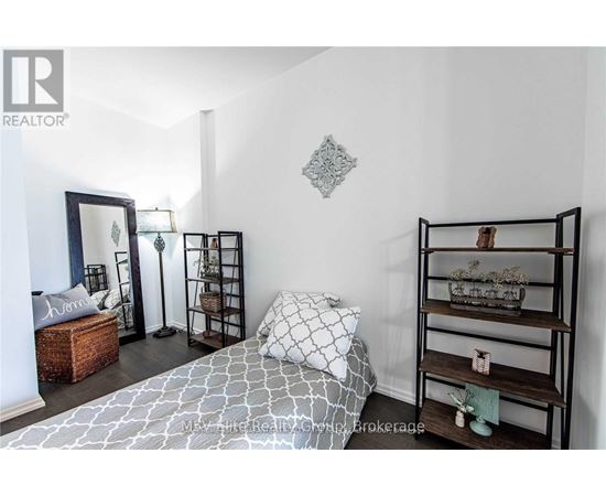 A bedroom with a bed, shelves, and a mirror.