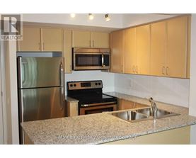 A kitchen with a stainless steel refrigerator, microwave, oven, and sink.