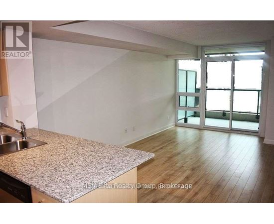 A kitchen with a sink and a counter top.