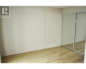 A room with a wooden floor and a sliding glass door.