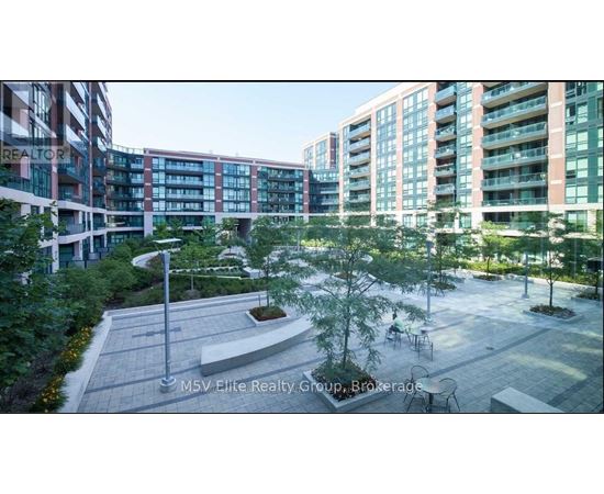 A courtyard with a tree and a bench in front of apartment buildings.