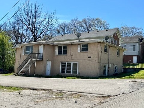 A two-story house with a satellite dish on the roof.