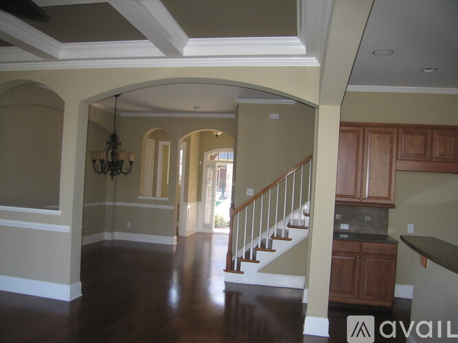 A spacious hallway with a staircase leading to the second floor.