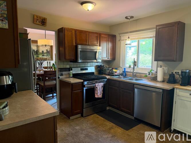 A kitchen with brown cabinets and a black stove top.