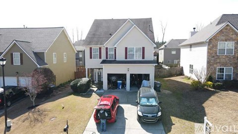 A house with a red car parked in front of it.