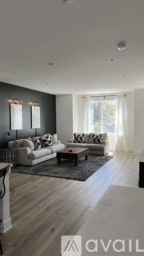 A modern living room with a white sofa and a coffee table.