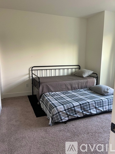 A bedroom with a bed and a bedside table.