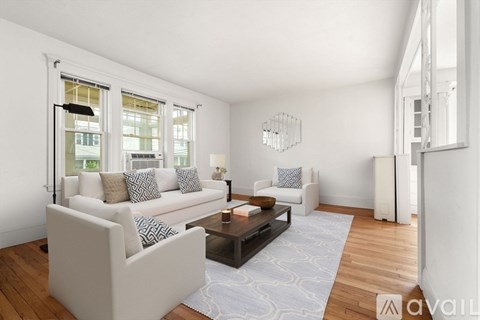 A living room with a white couch and a coffee table.