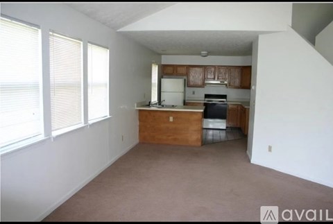 A kitchen area with a counter and a stove top oven.
