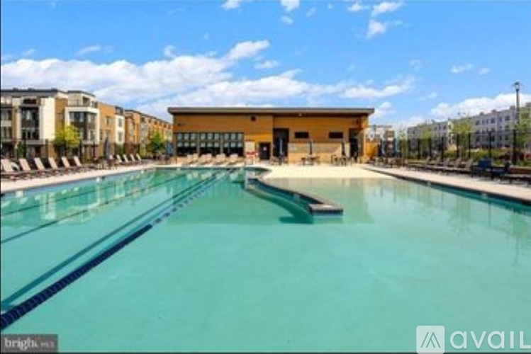 A large swimming pool with a building in the background.