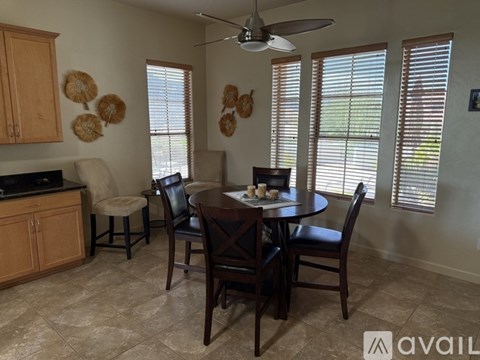 A dining room with a table set for four.