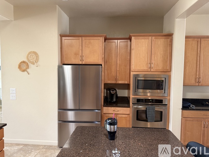 A kitchen with wooden cabinets and stainless steel appliances.