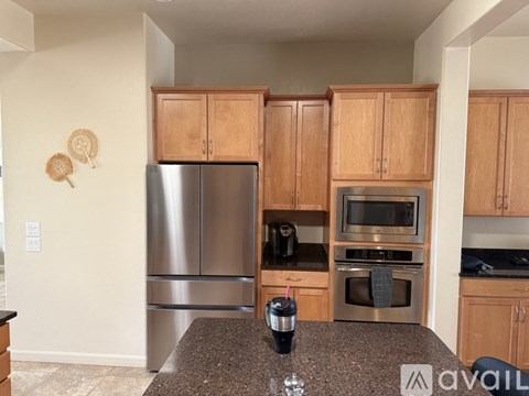 A kitchen with wooden cabinets and stainless steel appliances.
