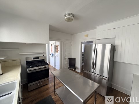 A kitchen with a stainless steel refrigerator and oven.