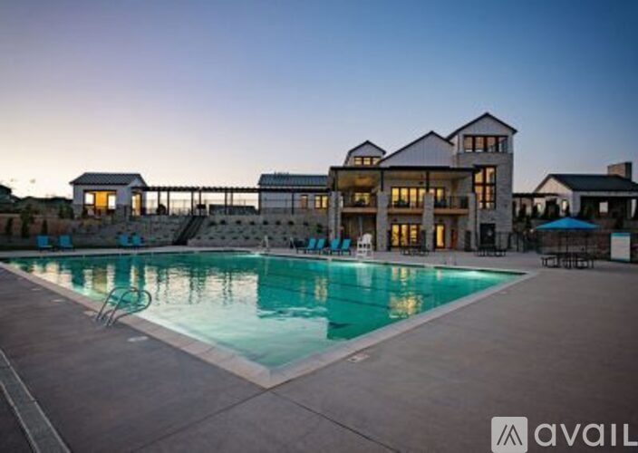 A large house with a pool in front of it.