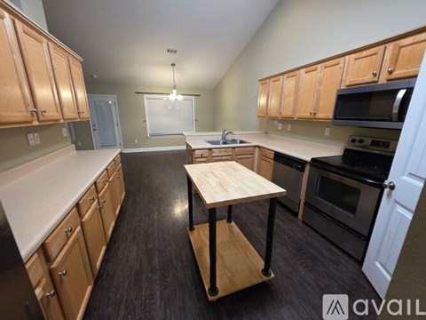 A kitchen with wooden cabinets and a white countertop.