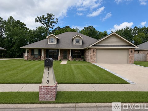 A house with a brick mailbox at the entrance.
