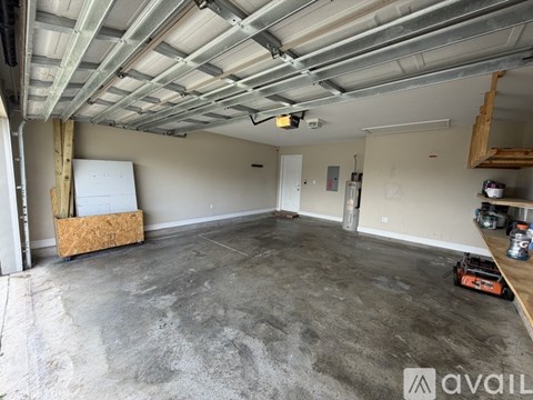 A large empty room with a concrete floor and a metal roof.