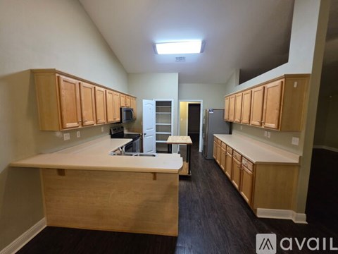 A kitchen with wooden cabinets and a counter top.